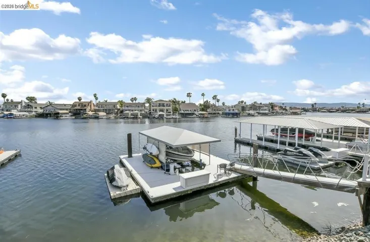 Private boat dock with covered slip, featuring a gangway and direct water access
