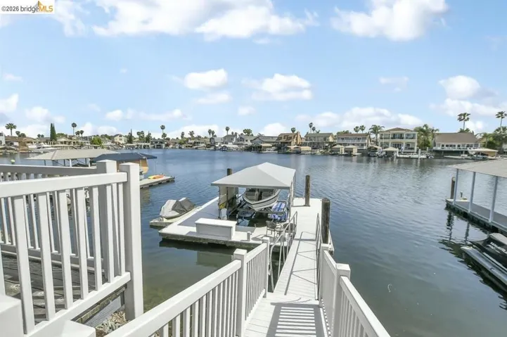 Waterfront property featuring a private boat dock with covered slip, a separate uncovered personal watercraft dock, and direct access to the expansive waterway