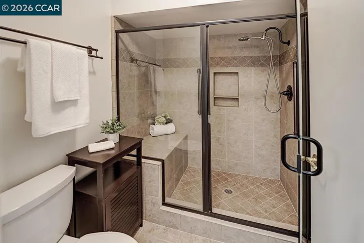 shower features built-in seat and grab bar