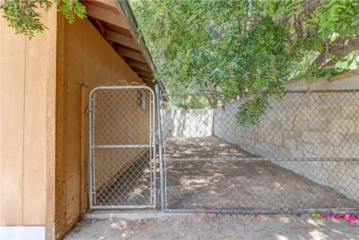 Fenced yard off the back of garage.