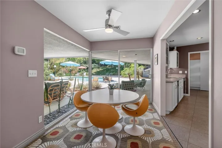 Informal family dining room overlooking pool area