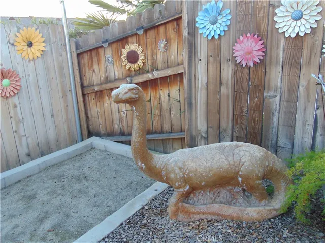 Sand box with dinosaur watching