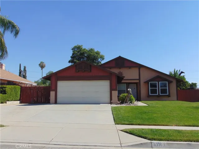 extra wide driveway with double gates to back yard.