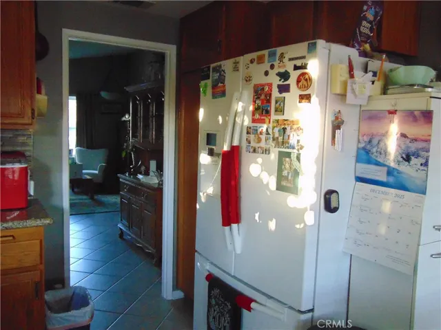 from kitchen towards living room. Large tile flooring.