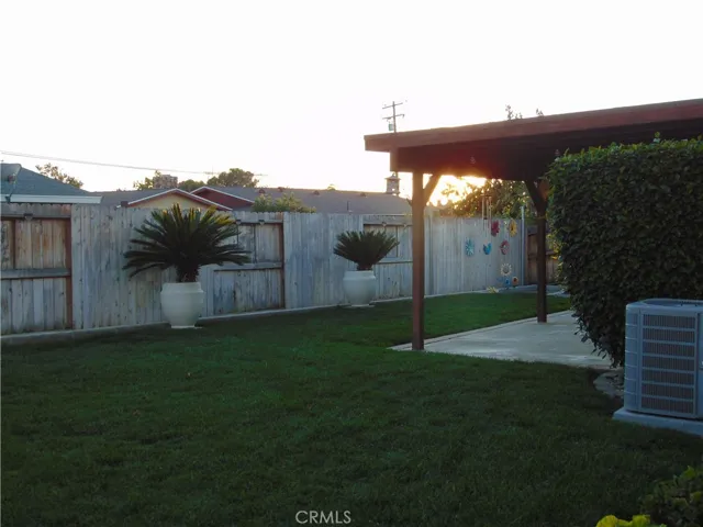 back yard, covered patio, sand box in right corner