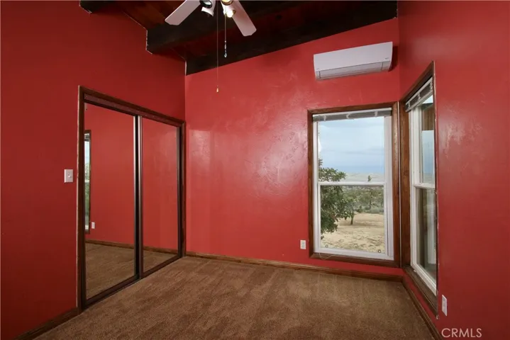 Bedroom, ceiling fan, mini-split and two windows facing north and east
