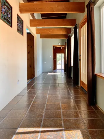 Main hallway. Entrance to kitchen, living room, doors out to back patio.