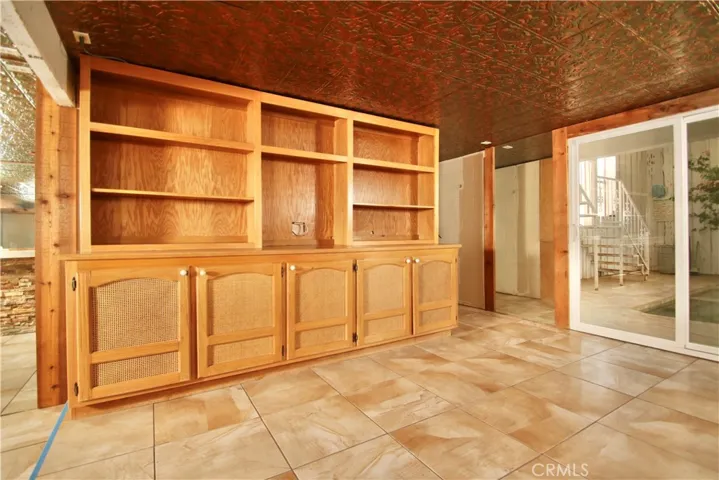 Downstairs storage and shelving.  Slider out to indoor pool