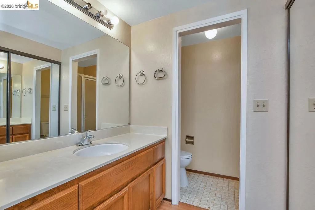 Bathroom vanity featuring a single basin, chrome faucet, and integrated countertop
