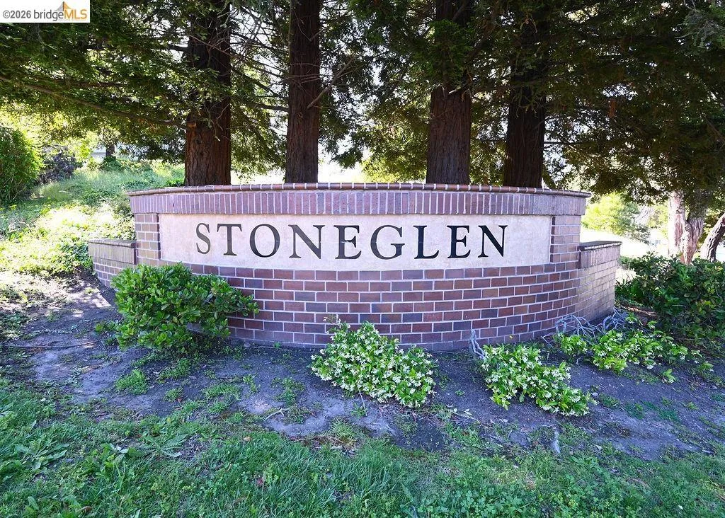 Stoneglen entrance monument featuring brick construction and a light-colored sign panel