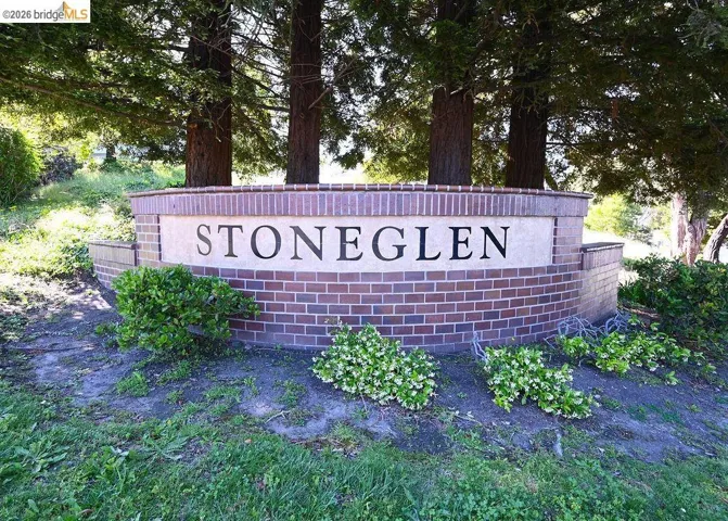 Stoneglen entrance monument featuring brick construction and a light-colored sign panel