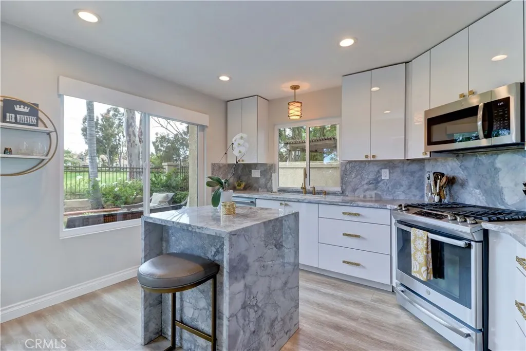 Custom made marble island and electric window shade.