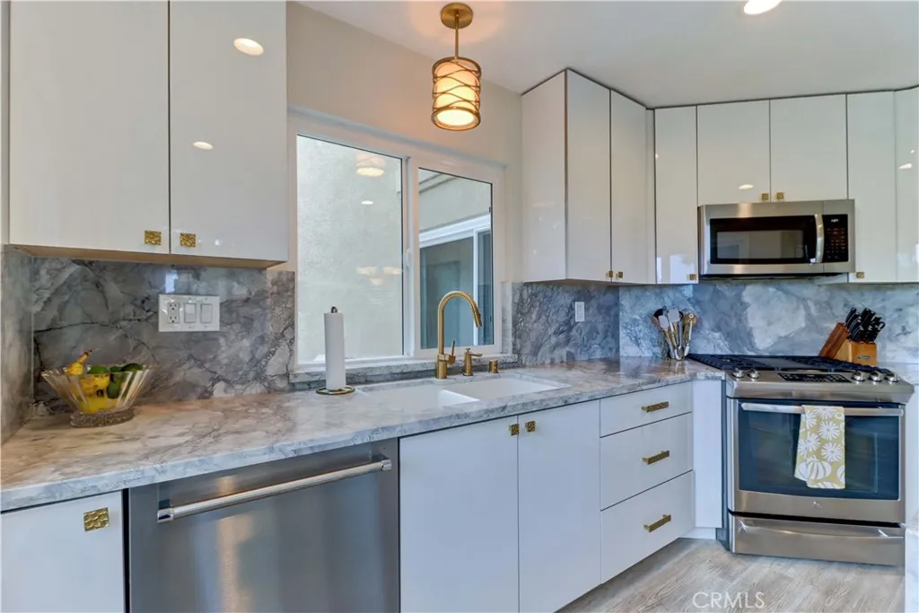 European cabinets with brushed gold pulls.