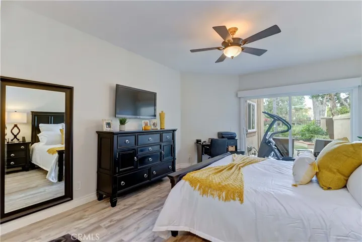 Main floor primary bedroom with ceiling fan and newer dual pane windows.