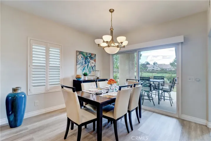 Formal dining room with shutters and electric window covering.