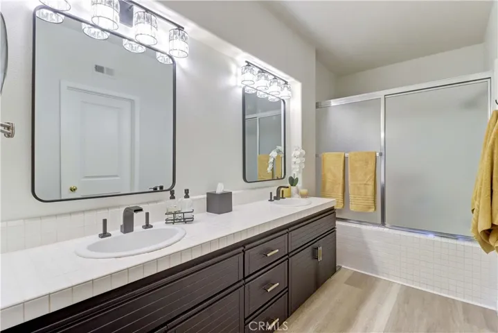 Main floor primary bathroom with dual sinks.