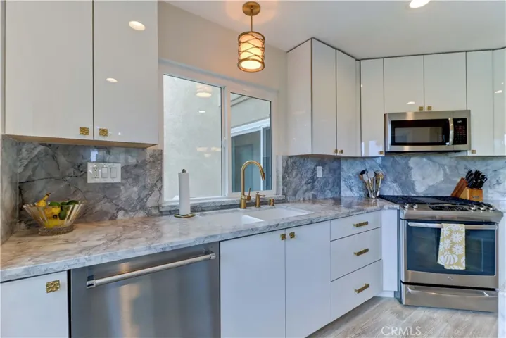 European cabinets with brushed gold pulls.