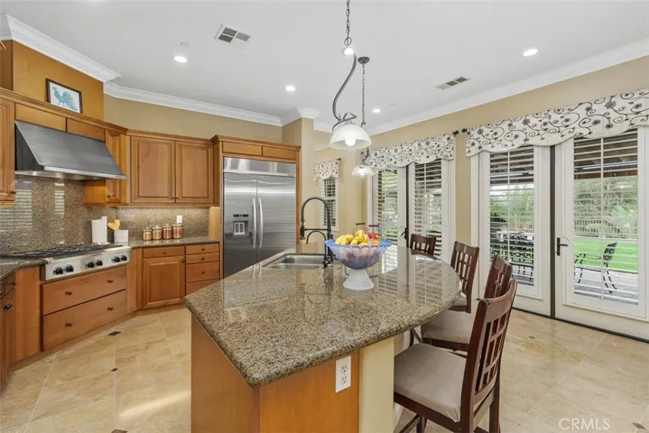 Kitchen with granite countertop, pendant lights, marble flooring, and two double French doors