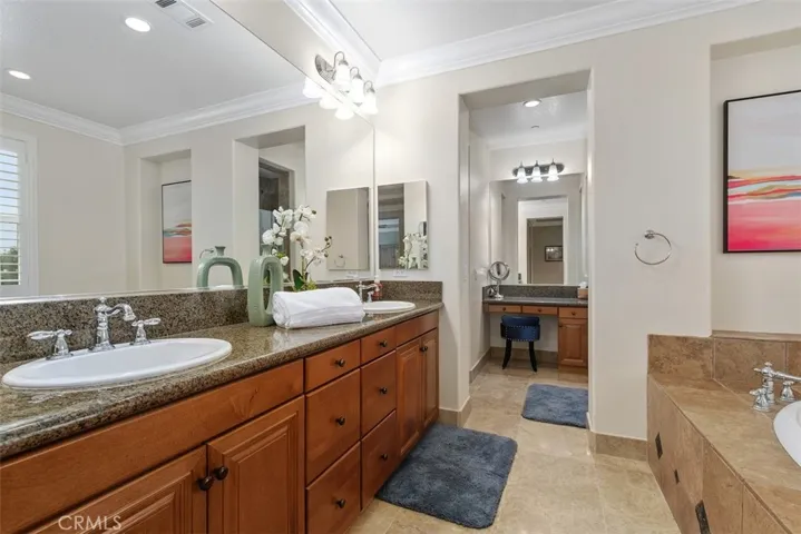 Primary bathroom with double sink and vanity desk