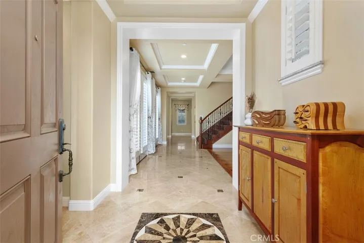Front entry with medallion, tray ceilings, and two double French doors