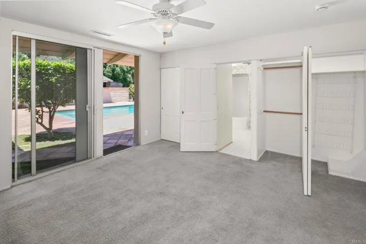 One of two bedrooms with access to pool area.