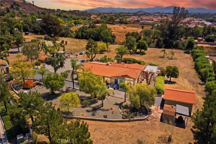 Digitally enhanced photo w aerial view of front of house and property