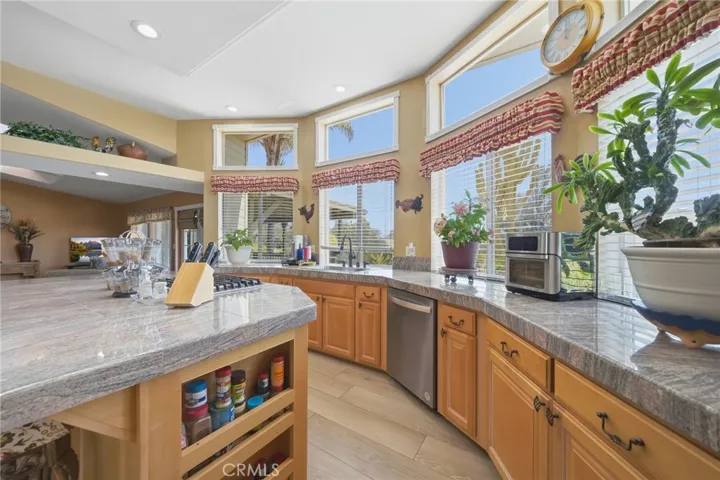 Kitchen w smart storage and brand new dishwasher w windows overlooking the rear of property
