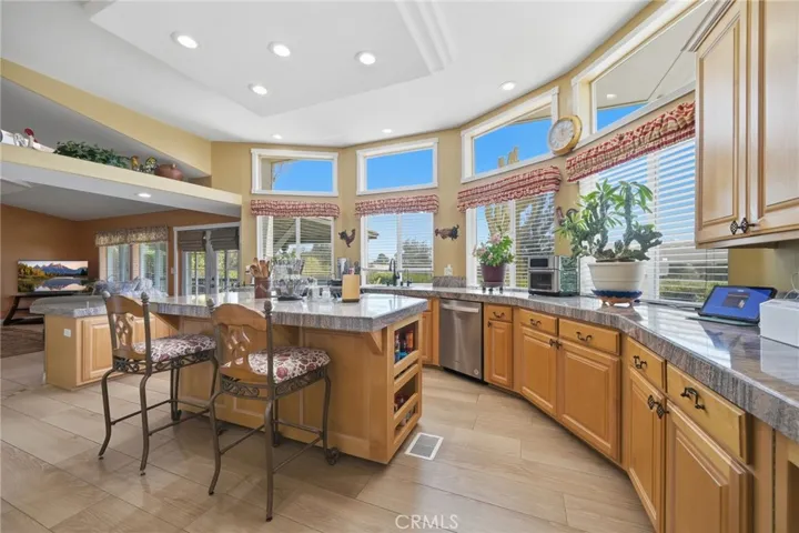Expansive kitchen w loads of cabinet space, granite countertops and amazing natural light from the bank of windows.