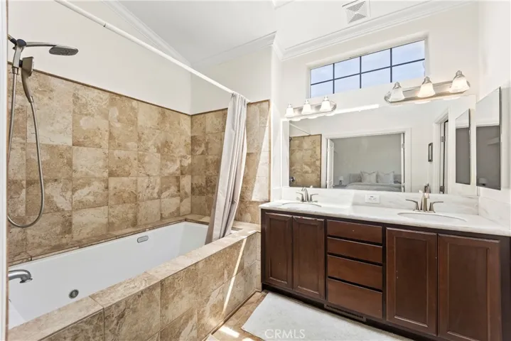 master bathroom with shower in tub set up for everyday convivence and easy bathing