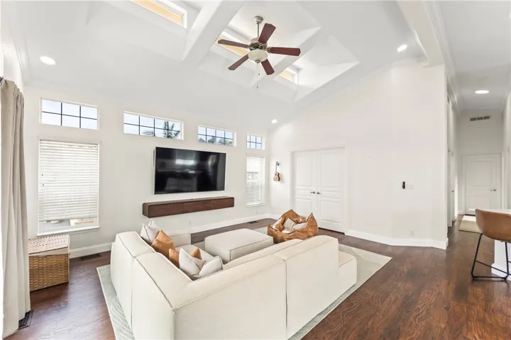 light and bright, the spacious living room features high ceilings, abundant windows and recessed lighting for open airy feeling