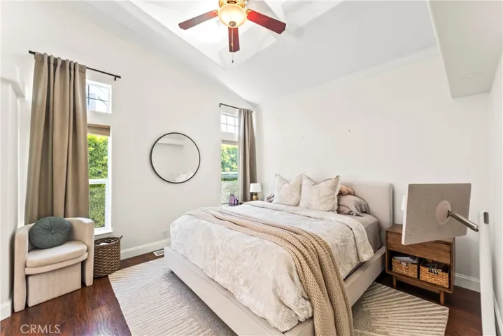 Spacious master bedroom that is light and bright, featuring high ceiling and a ceiling fan for added comfort