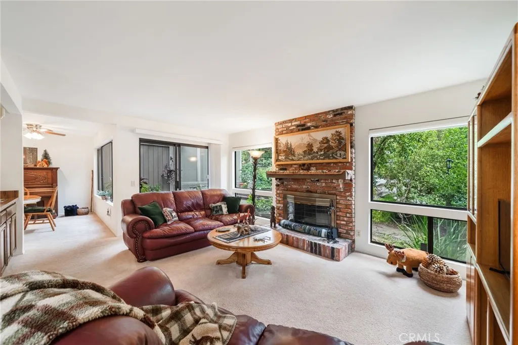 Livingroom with brick fireplace and view of rear yard