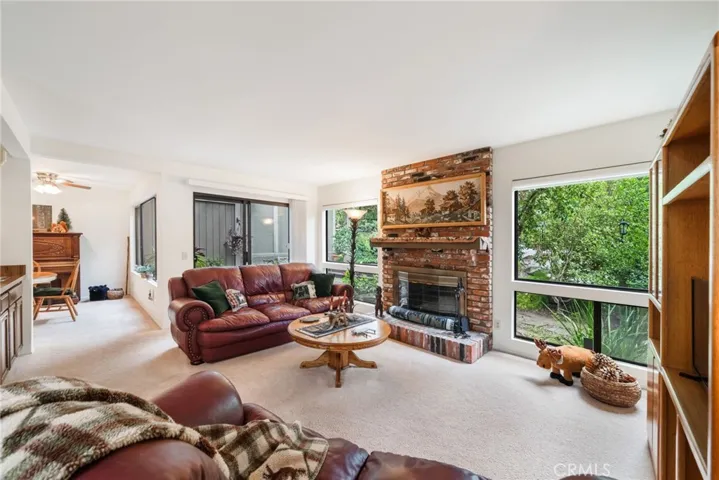 Livingroom with brick fireplace and view of rear yard