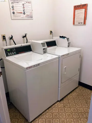 Dedicated laundry area featuring a white top-load washing machine and a white front-load dryer
