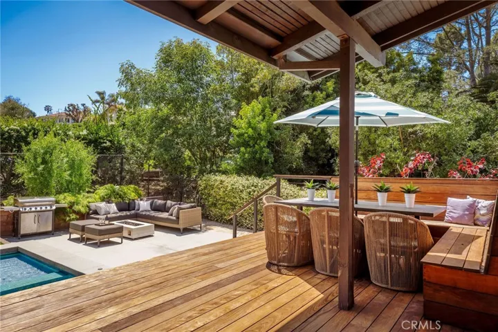 Deck, seating, and patio seating with fire pit near pool