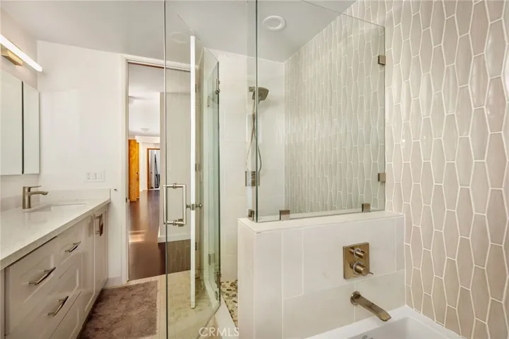 Upstairs hallway, bathroom, separate shower, and tub
