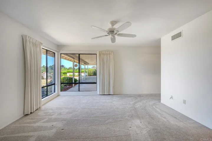 Primary bedroom ~ turn those windows into sliding glass doors and awesome patio access is created...