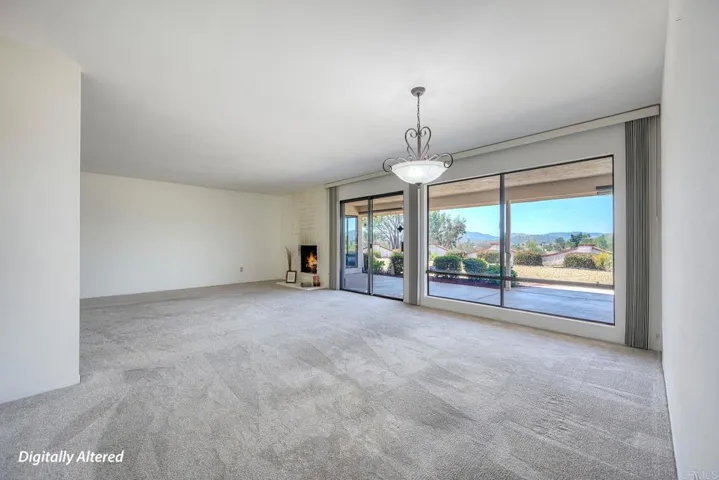 View of LR from the dining room area~ sliding glass door entry to back patio & yard.