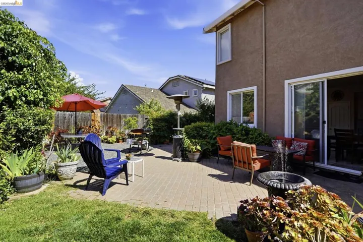 Expansive paver patio with a lush lawn border