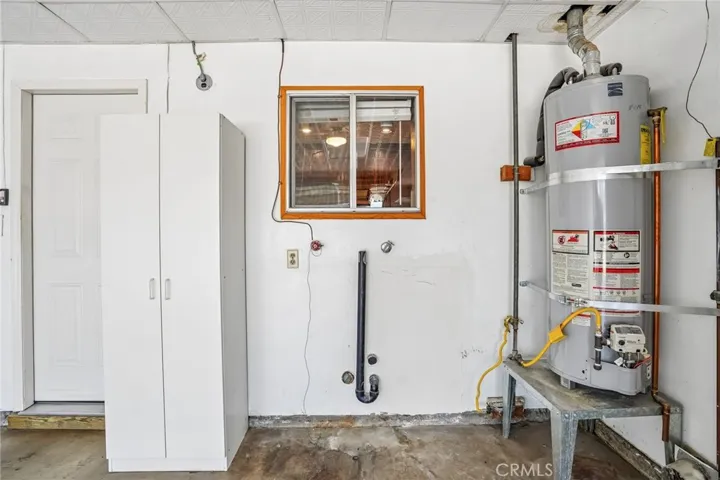 Laundry Area - The garage also includes convenient washer and dryer hookups with dedicated utility connections and nearby storage cabinetry, creating a practical laundry area just outside the kitchen for added everyday convenience and functionality.