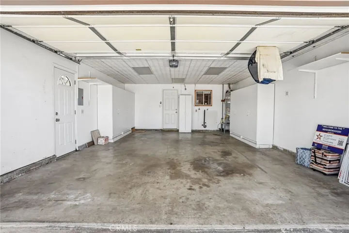 Garage - This spacious attached garage offers ample room for parking, storage, and workspace needs. Outfitted with extensive built-in cabinetry and shelving, the space provides exceptional organization and functionality for tools, seasonal items, or hobby equipment. Bright overhead lighting, washer and dryer hookups, and direct exterior access add everyday convenience, while the generous layout offers flexibility for additional storage or workshop potential.