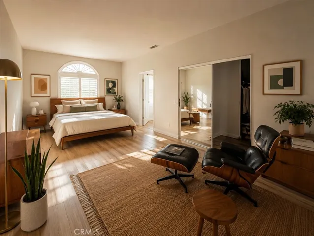 master bedroom with mirror doors to walk-in closet (This image has been virtually staged to illustrate the potential use of space. Furnishings, finishes, and décor shown may not exist in the home and are not included in the sale.)