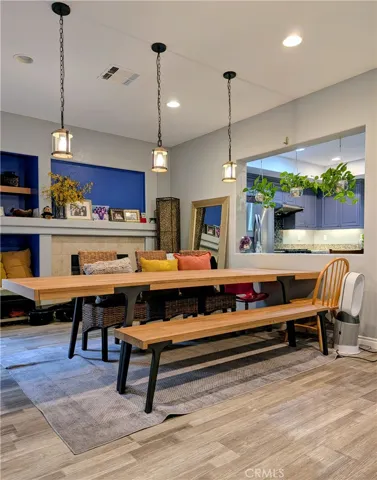 Beautifully styled dining area, custom pendant lighting and seamless sightlines into the kitchen