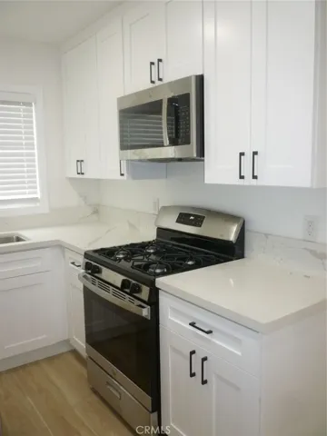 All new white shaker style cabinets with white quartz counter tops. New kitchen appliances as well.