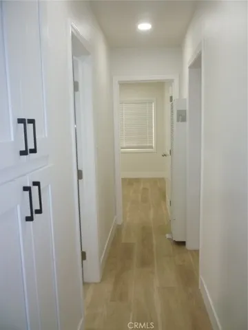 Hallwa with linen closets.  Bathroom is on the left and the living room is to the right.