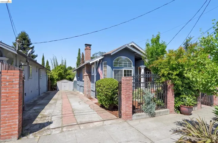 Charming single-story residence with a distinctive arched window, brick chimney, and mature front landscaping. AI-Generated