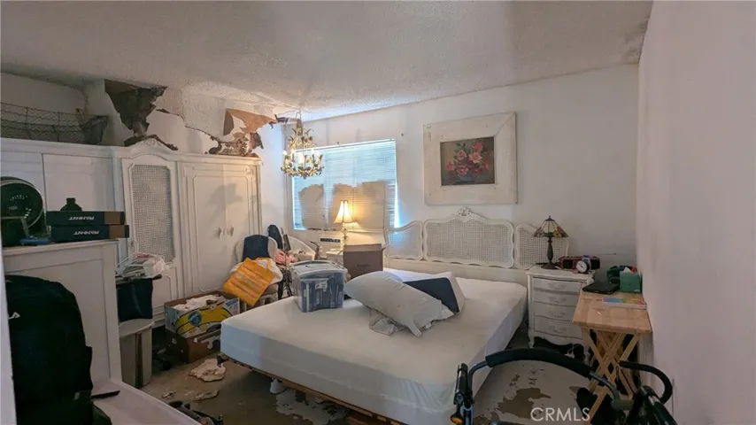Primary Bedroom with Ceiling that has falling down