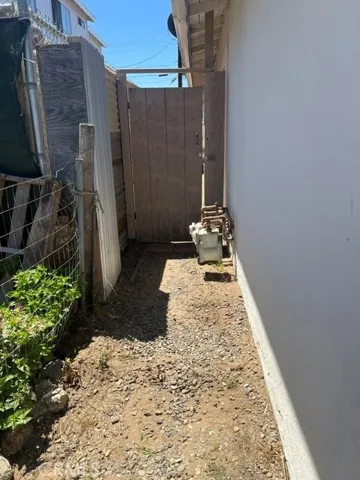 Outside path to back of House 1 leading to House 2