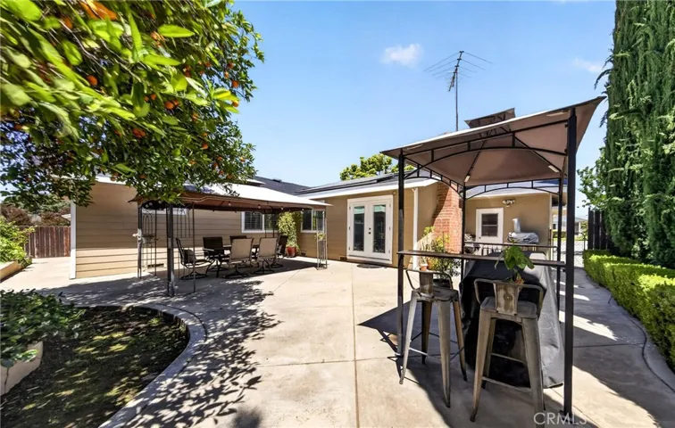 Beautiful backyard with patio and mature fruit trees.