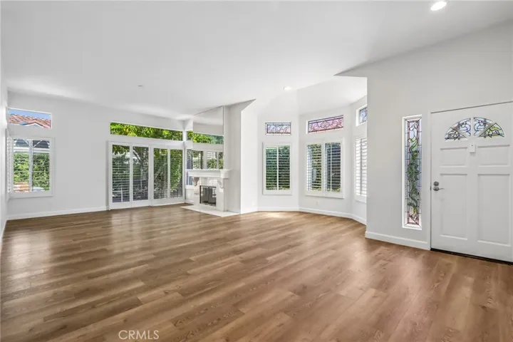 Expansive Living Room with Dining Area Centered Around an Exquisite Marble Fireplace